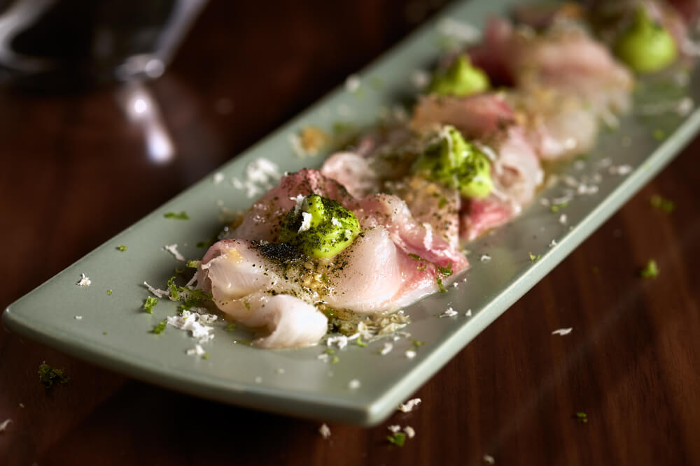 Stone bass carpaccio with avocado purée, horseradish and ginger dressing